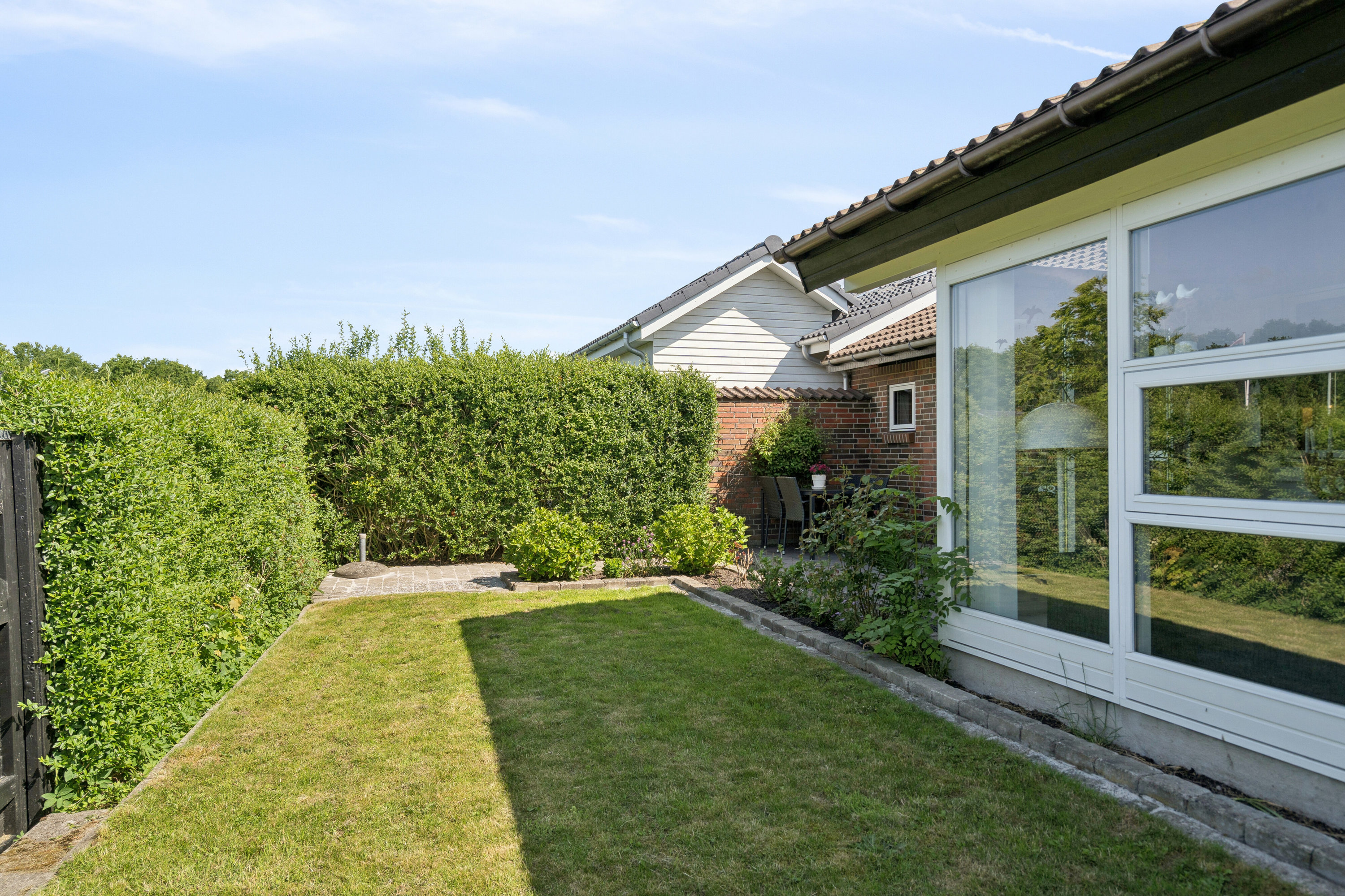 Fremhævet set fra haven billede i fuldskærmstilstand. Billede af Tranehøjen 286, Dyrup, 5250 Odense SV