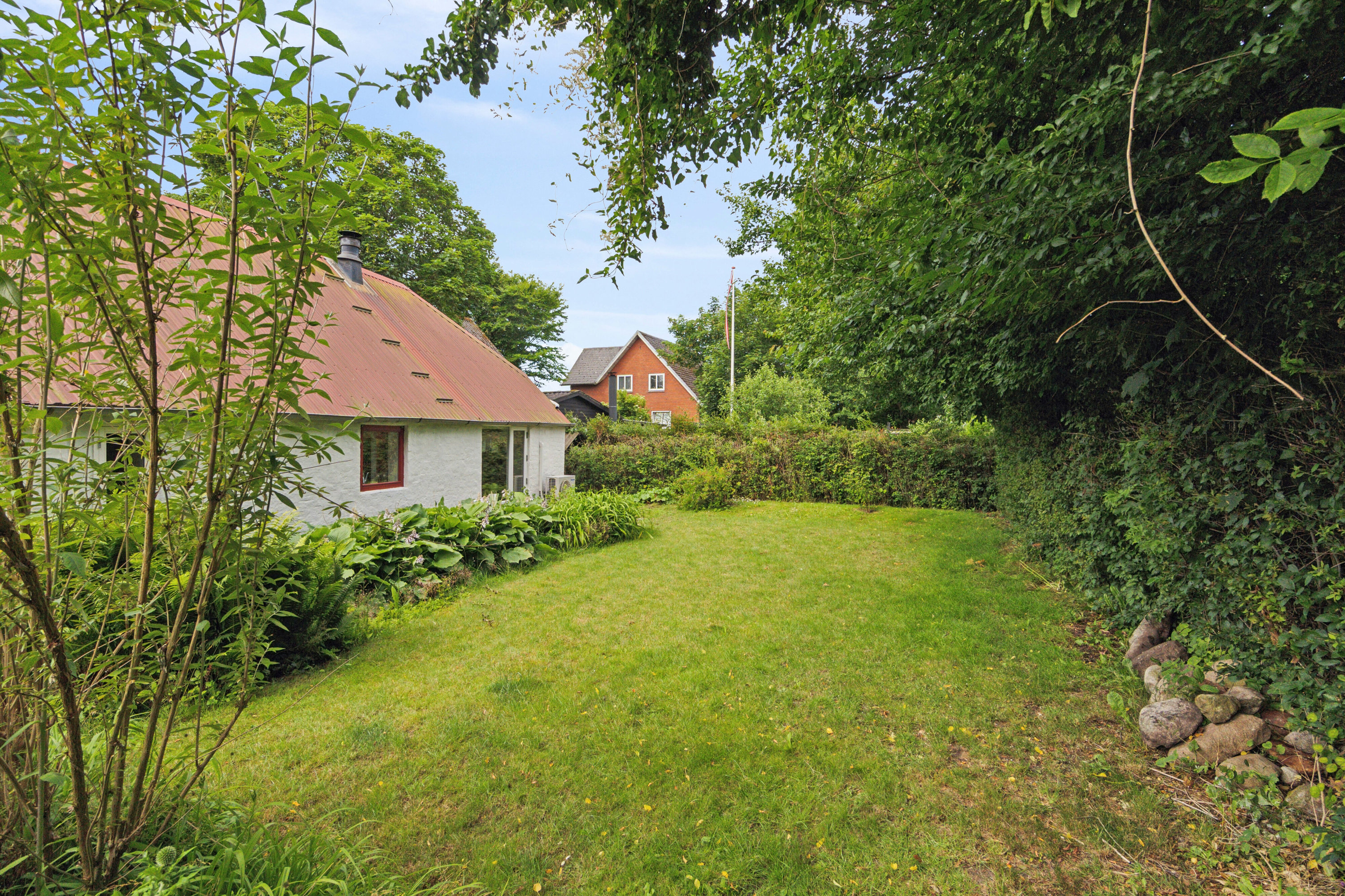Fremhævet set fra haven billede i fuldskærmstilstand. Billede af Borgergade 36, Koldby, 7752 Snedsted