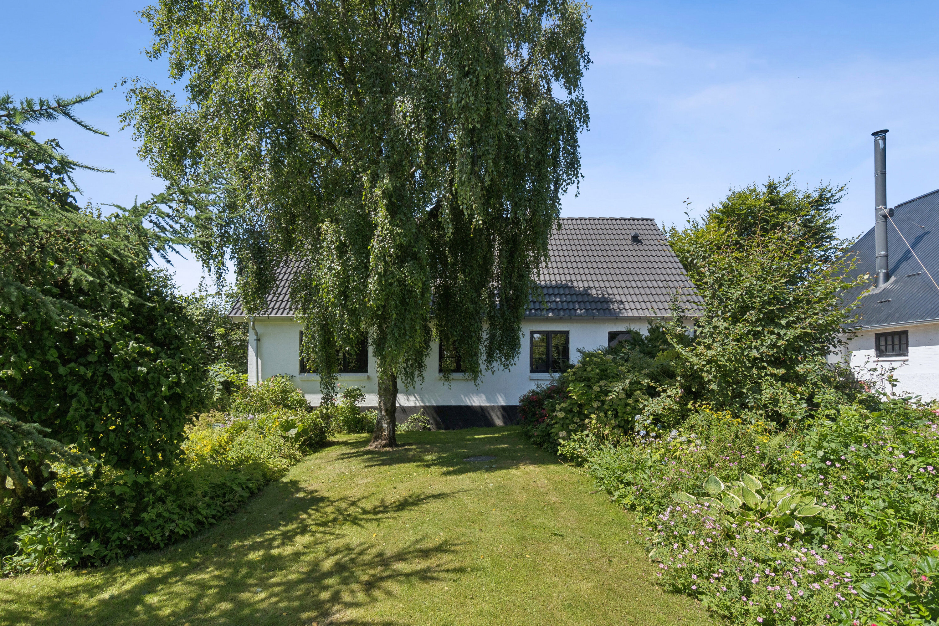 Fremhævet set fra haven billede i fuldskærmstilstand. Billede af Legindvej 39, Sønderhå, 7752 Snedsted